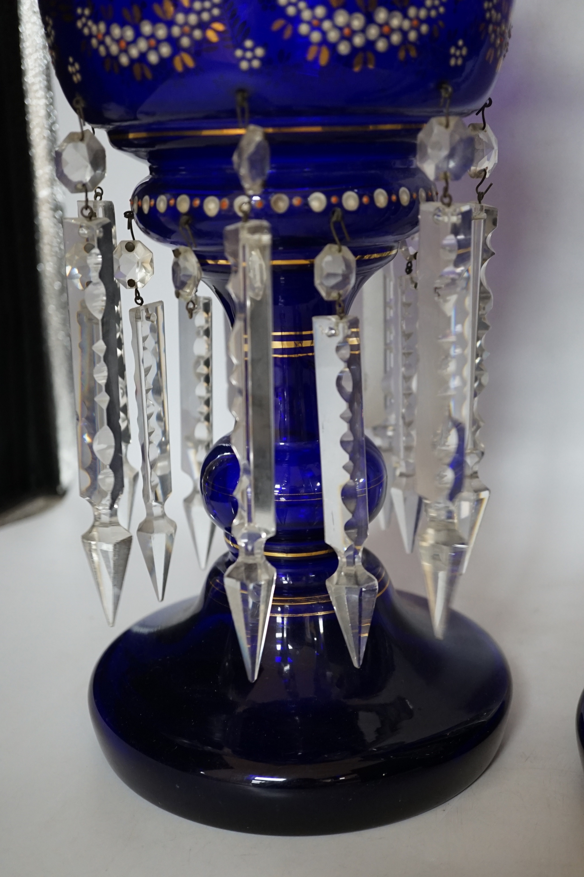 A pair of Victorian enamelled blue glass table lustres, 37cm high